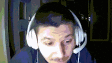 a man wearing headphones and a microphone is looking down