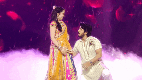 a man and a woman are dancing on a stage .