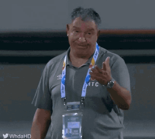 a man with a lanyard around his neck that says dfb on it