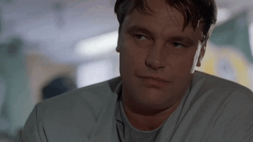 a close up of a man 's face in a hospital room