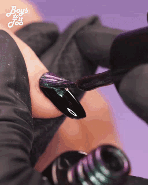 a close up of a person painting their nails with boys do it too
