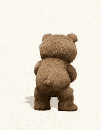 a teddy bear is holding a shaker in its hand .