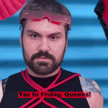 a man with a beard is tied up and has the words yaz to friday queens on the bottom