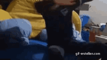 a person is laying on a bed with their feet up and a gif-erstellen.com watermark on the bottom