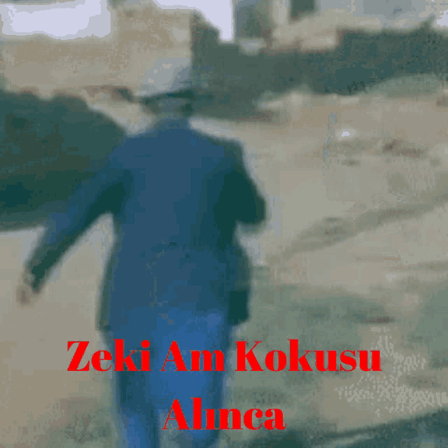 a man in a blue suit is walking with the words zeki am kokusu alnca in red letters