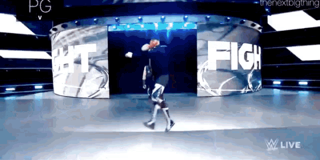 a man is walking in front of a sign that says fight on it