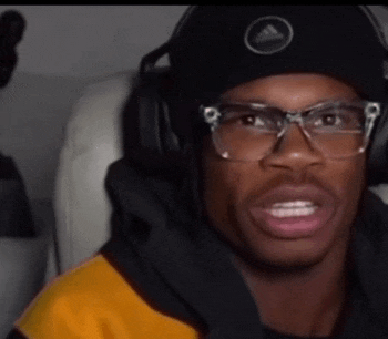 a man wearing glasses and a beanie with an adidas logo on it