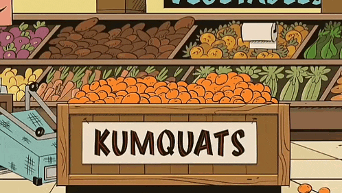 a box of kumquats sits in front of a grocery store display