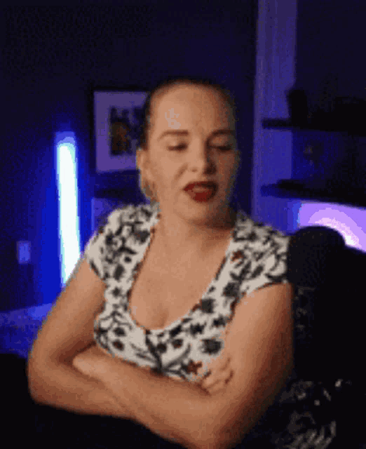 a woman with her arms crossed is sitting in a chair