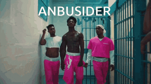 a group of men in pink prison uniforms are walking in a hallway with the words anbusider behind them