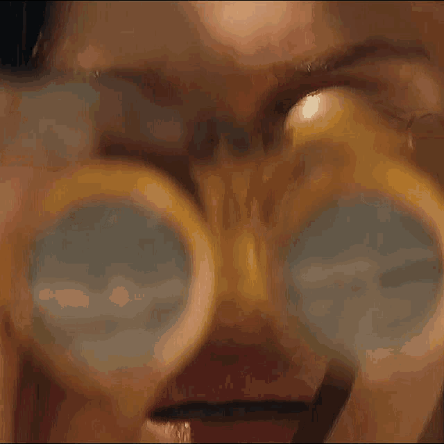 a close up of a woman 's face behind a glass