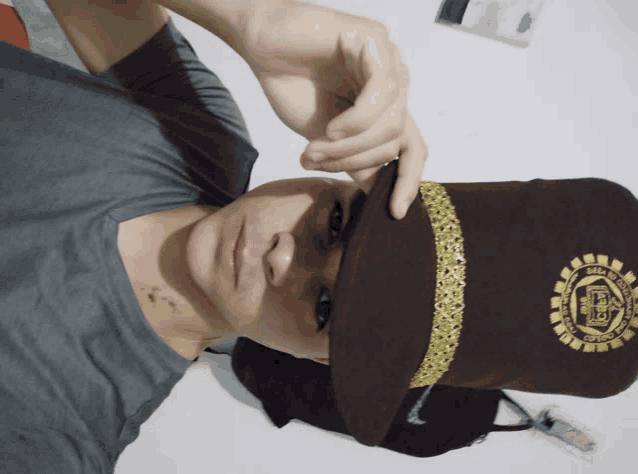 a man is wearing a hat with the letter b on the front