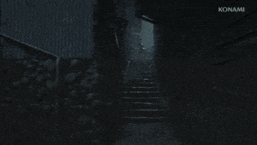 a person 's feet are shown in a dark room with konami in the corner