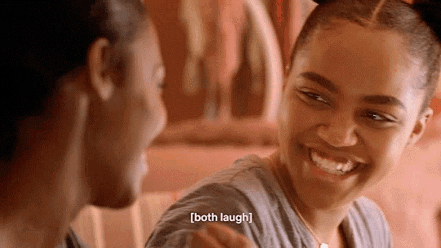 a man and a woman are laughing together and the woman says both laugh .