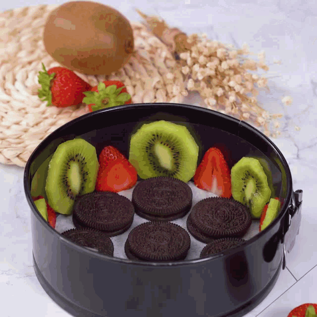 a black cake pan filled with oreos and fruit