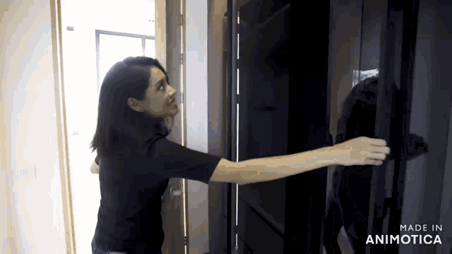 a woman is opening a door with the words made in animotica on the bottom