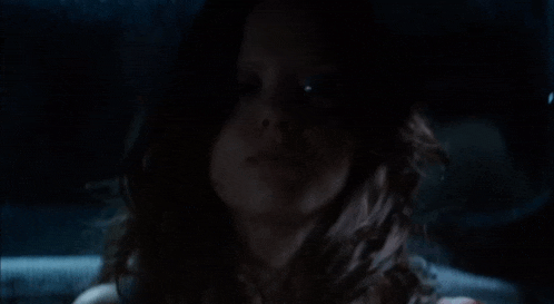 a close up of a woman 's face in the dark