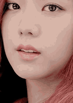 a close up of a woman 's face with red hair