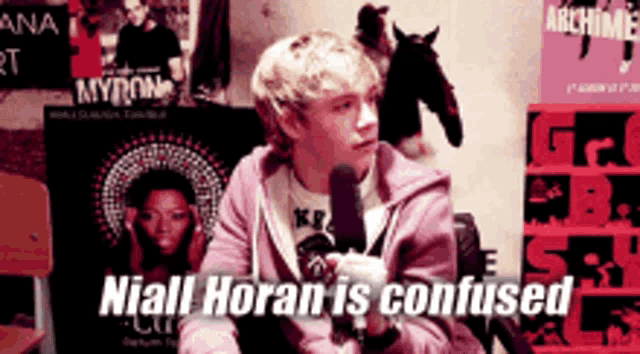 niall horan is confused while holding a microphone in his hand