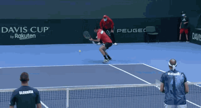 a man in a slovakia shirt watches a tennis match
