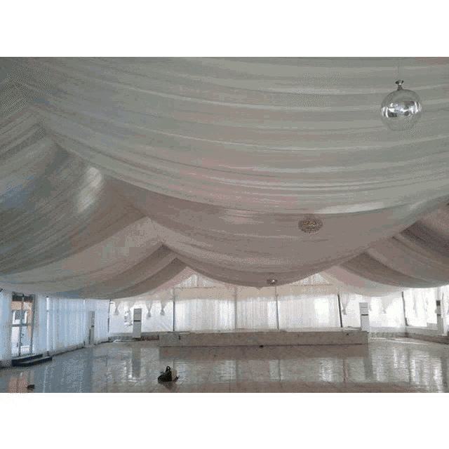 a large room with a white ceiling and a disco ball hanging from it