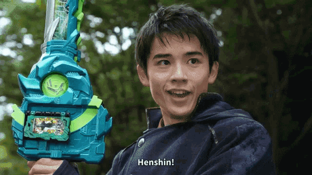 a young man holding a toy sword with henshin written on it