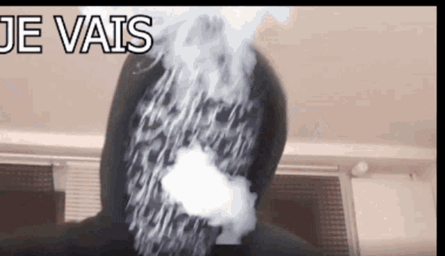a person with smoke coming out of their face and the words je vais below