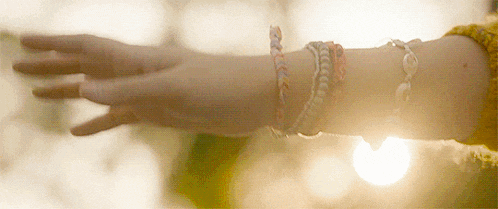 a close up of a woman 's arm with bracelets on