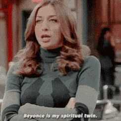 a woman with her arms crossed says beyonce is my spiritual twin .