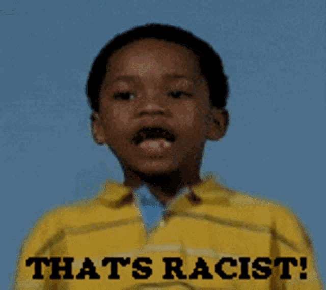 a young boy is wearing a yellow shirt that says that 's racist !
