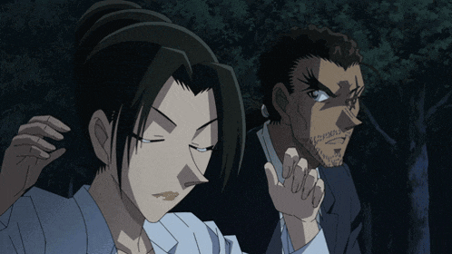 a man and a woman are standing next to each other and the man has a beard