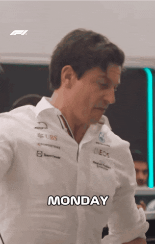 a man in a white shirt says monday in a room