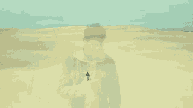 a man in a denim jacket is walking through the desert .