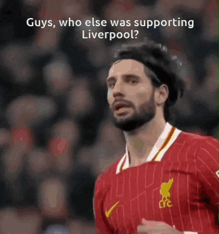 a man with a beard wearing a liverpool jersey