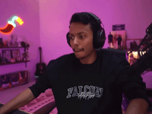 a man wearing headphones and a shirt that says falcons on it