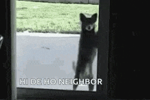 a dog is standing on its hind legs in front of a door and waving .