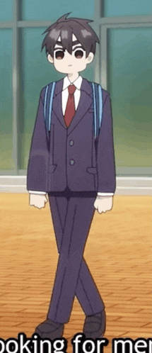 a boy in a suit and tie is walking with a backpack on his back