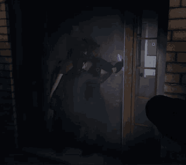 a person holding a purple object in front of a door in a dark room