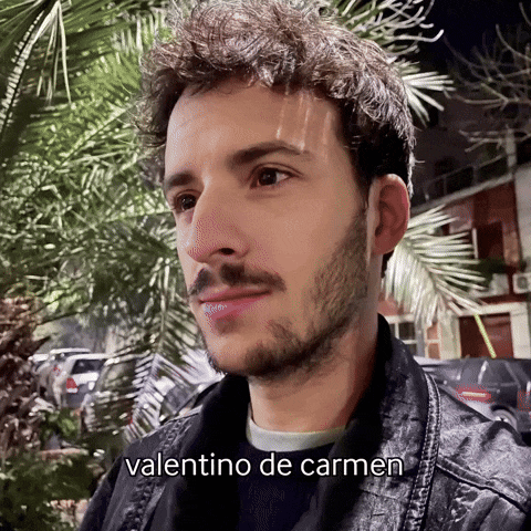 a man with a beard and the name valentino de carmen written on his face