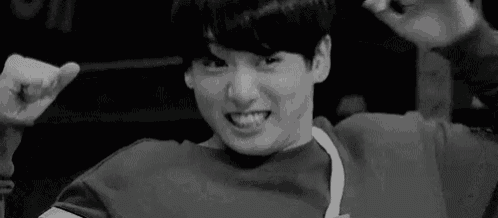 a black and white photo of a man making a funny face .
