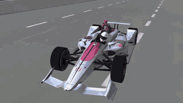 a white and red race car with a red helmet on the driver 's seat is flying through the air