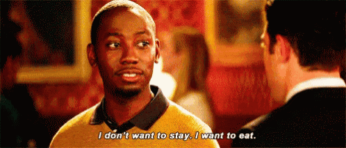 a man in a yellow sweater is talking to another man .