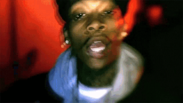 a close up of a man 's face with his mouth open