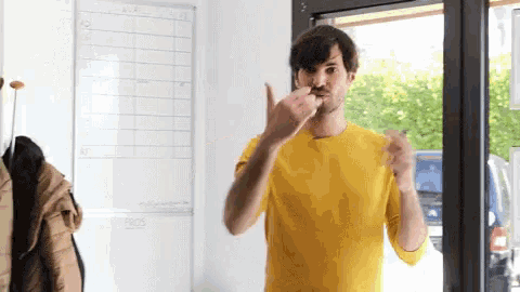 a man in a yellow shirt is standing in front of a white board with the word pros on it