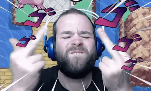 a man with a beard wearing headphones is giving the middle finger
