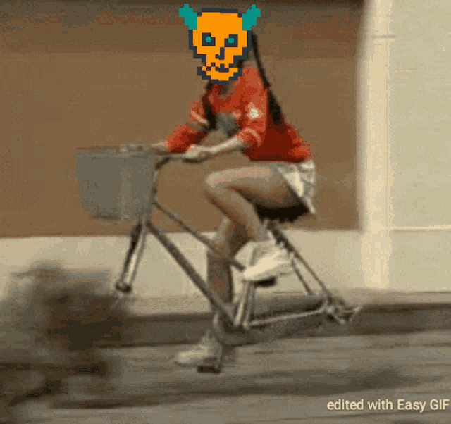 a woman riding a bike with a pixelated skull on her face