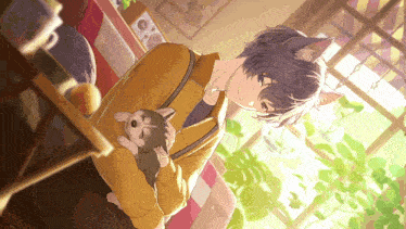 a boy with cat ears is holding a puppy in his arms