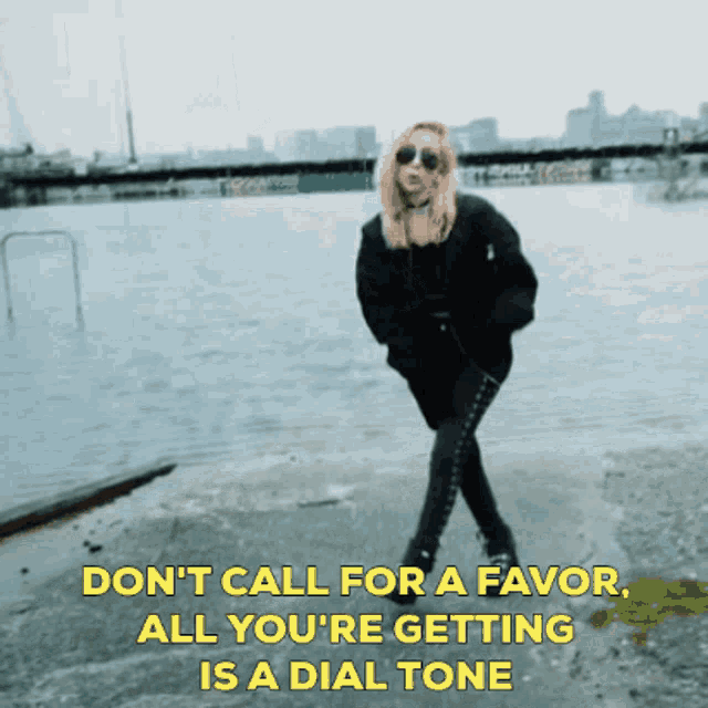 a woman with pink hair is standing in front of a body of water with the words " don t call for a favor