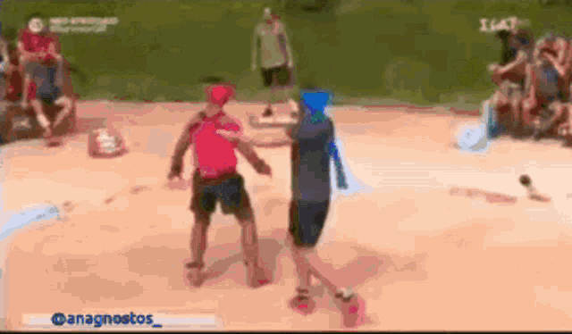 a man in a red shirt is standing next to a man in a blue shirt