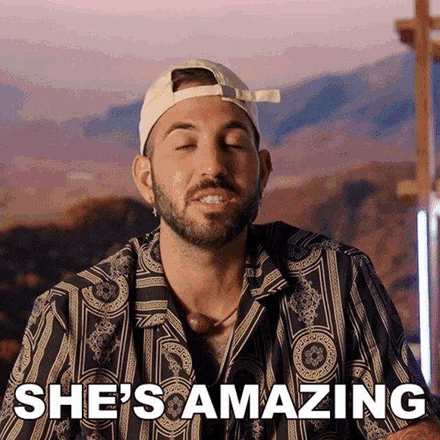 a man wearing a hat and a striped shirt says she is amazing